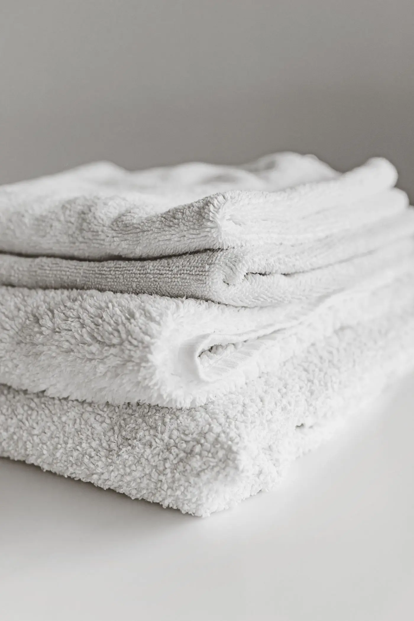 Folded white towels in soft natural light