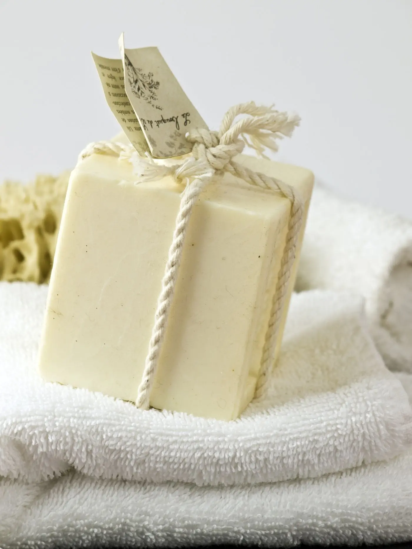 Pale soap bars resting on folded white towels